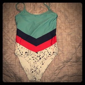 Turquoise, blue, and pink one piece bathing suit.